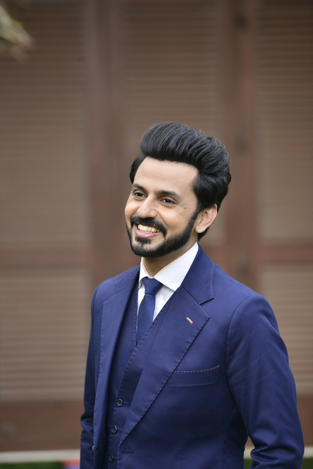 Portrait of a man in a suit with a confident smile