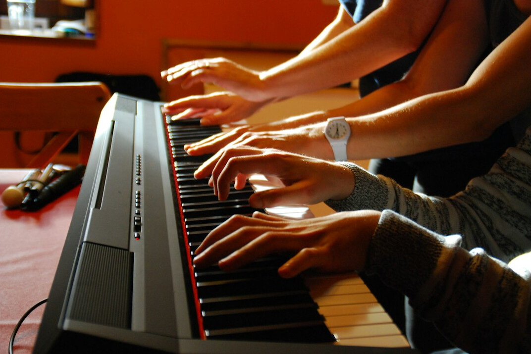 Hands typing on a laptop keyboard at a desk