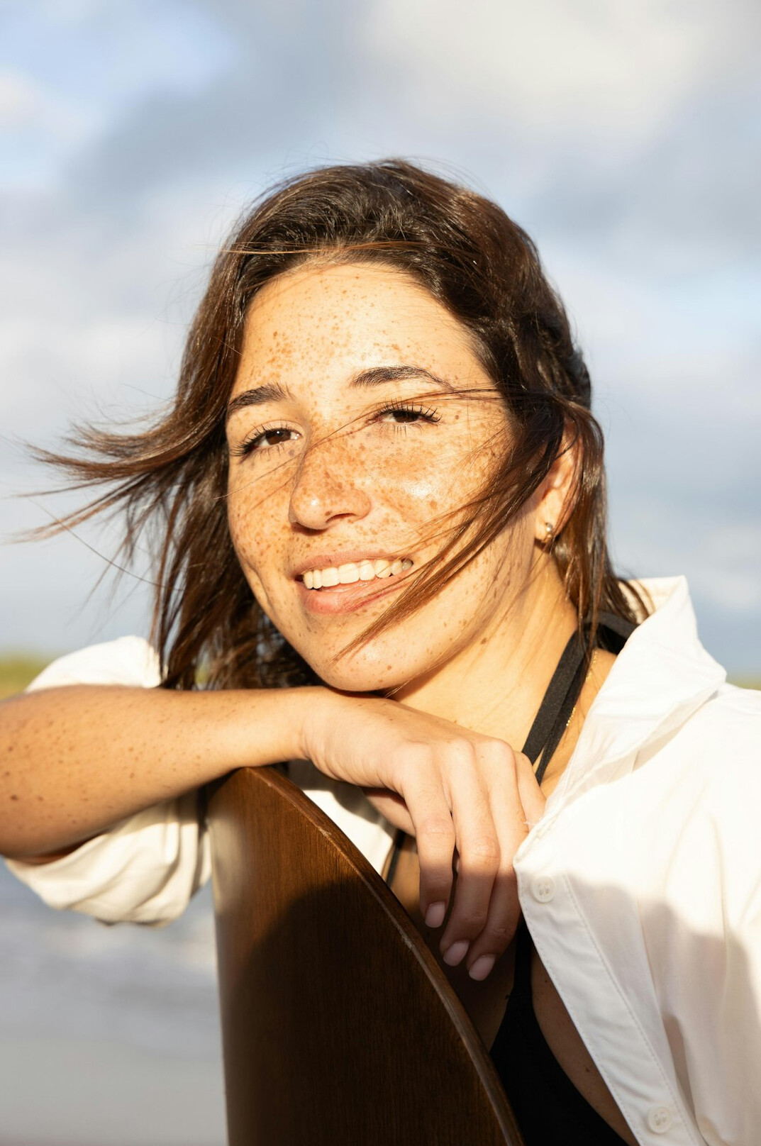 Portrait of a young woman with brown hair smiling